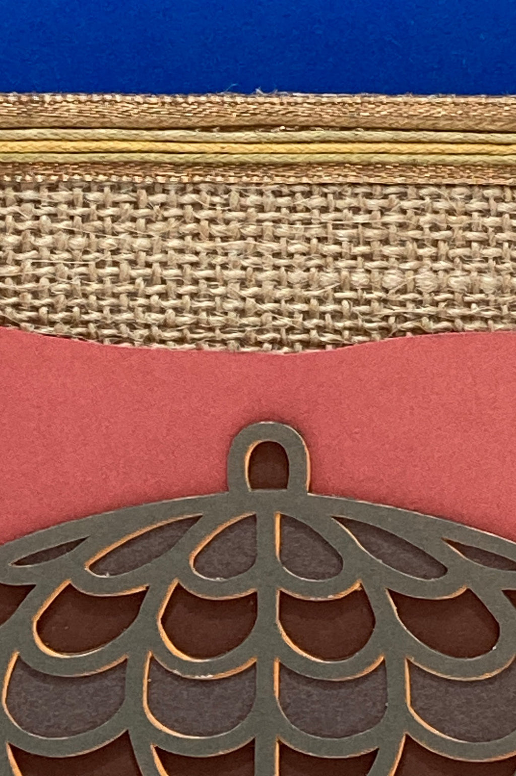 Close-up of the layered acorn motif and textured burlap-style paper.