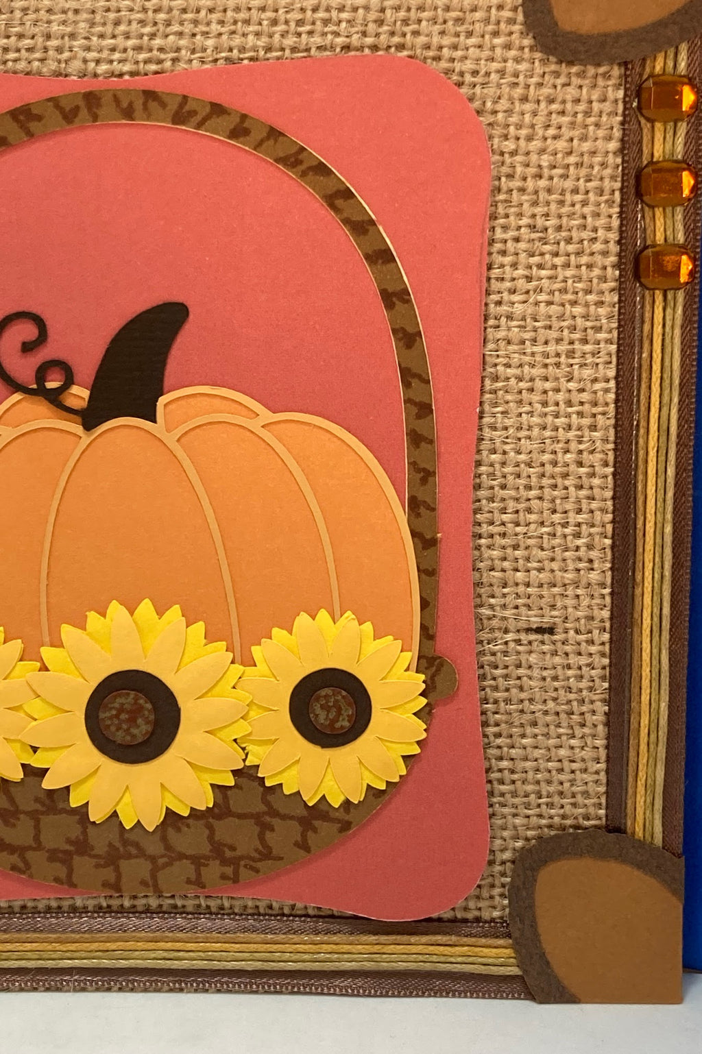 Detail of the pumpkin, layered yellow sunflowers and decorative border.