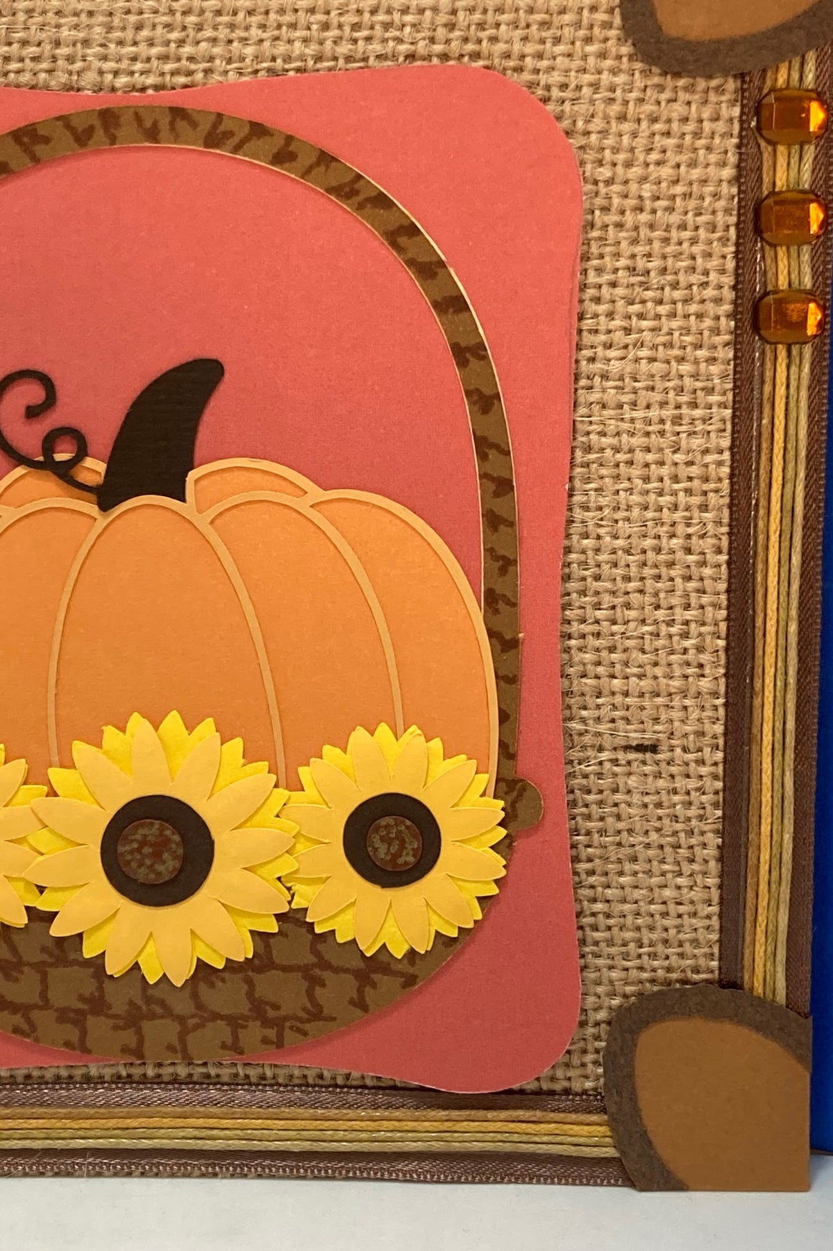 Detail of the pumpkin, layered yellow sunflowers and decorative border.