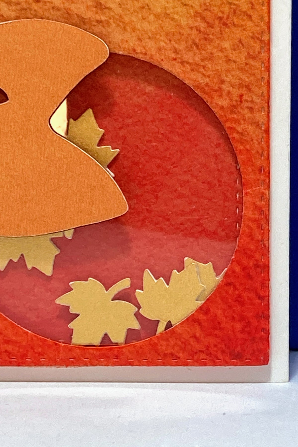 Close-up of the circular shaker window containing small leaf shapes.