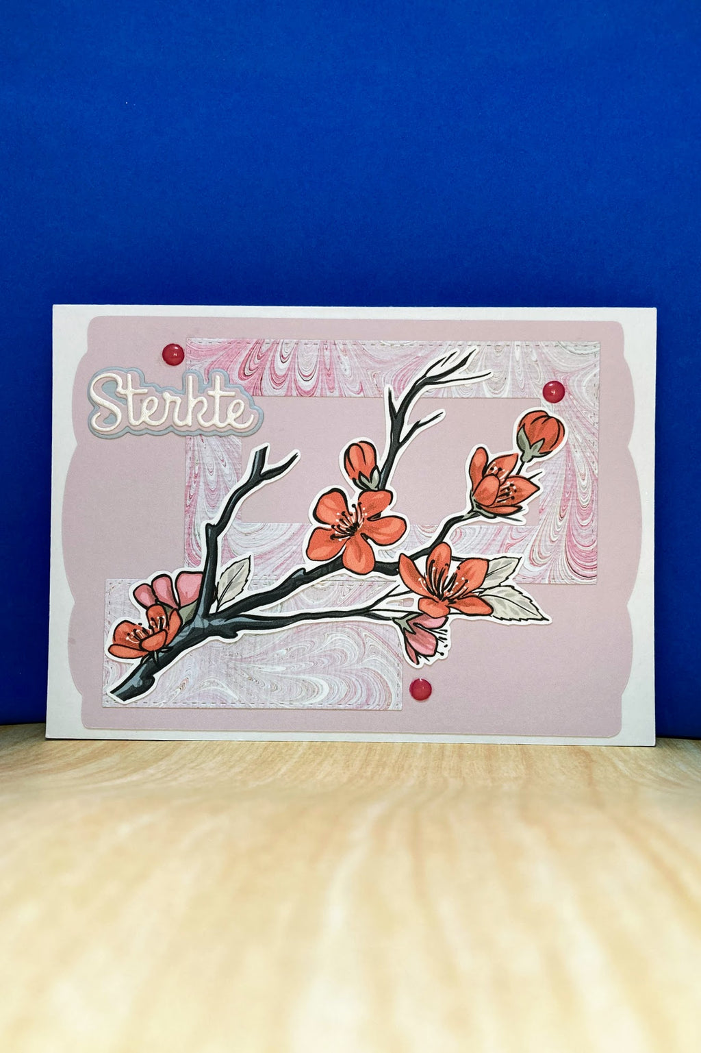 Handmade STERKTE sympathy card with plum blossom branch and pink marble-patterned panels
