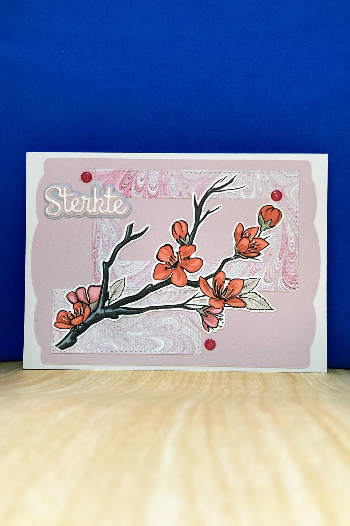 Handmade STERKTE sympathy card with plum blossom branch and pink marble-patterned panels