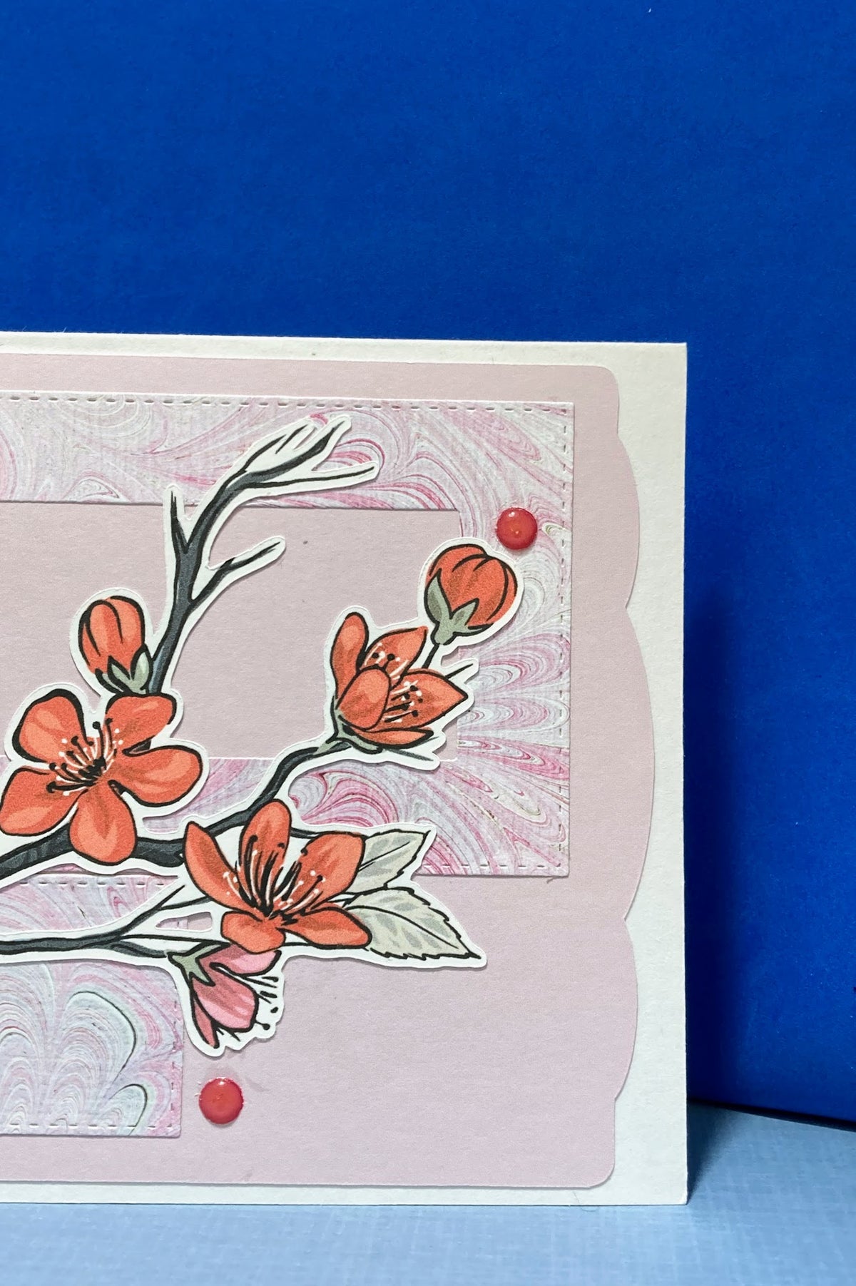 Close-up of the plum blossom branch and marble-patterned panels on the sympathy card